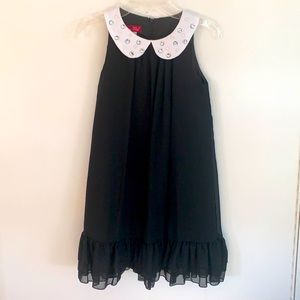 Classy black, pleated A-line dress with layered ruffles at the hem.